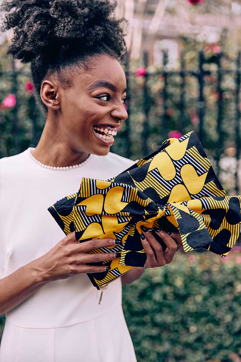 Goldenrod with blue and white print Ankara fabric. Adjustable shoulder stripes.