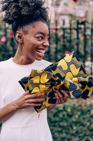 Goldenrod with blue and white print Ankara fabric. Adjustable shoulder stripes.