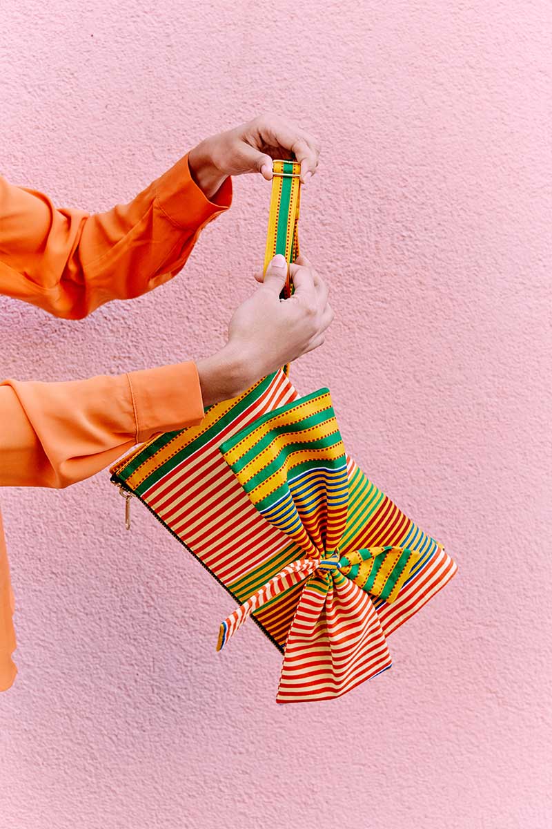Goldenrod with orange, green, blue and red colored striped print Ankara fabric. Adjustable shoulder stripes.